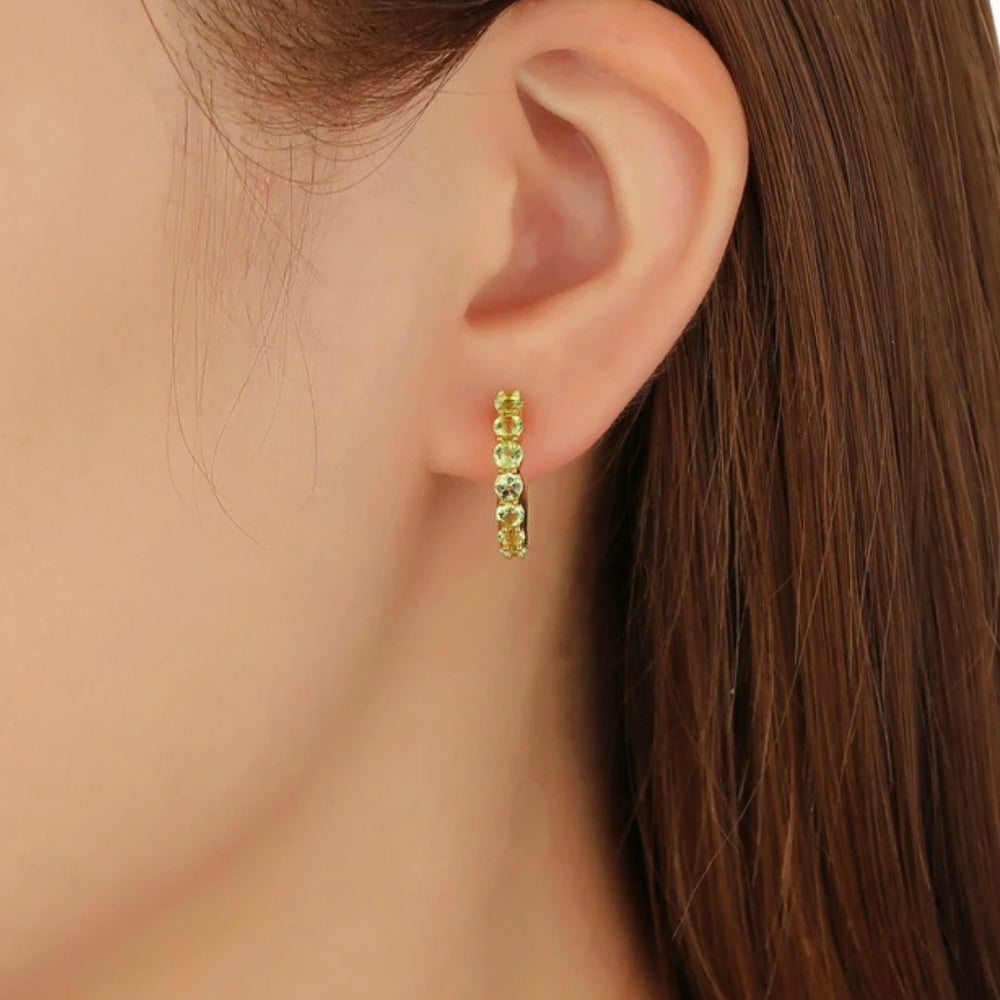 Peridot huggie hoop earrings, Gold Plated, worn on ear