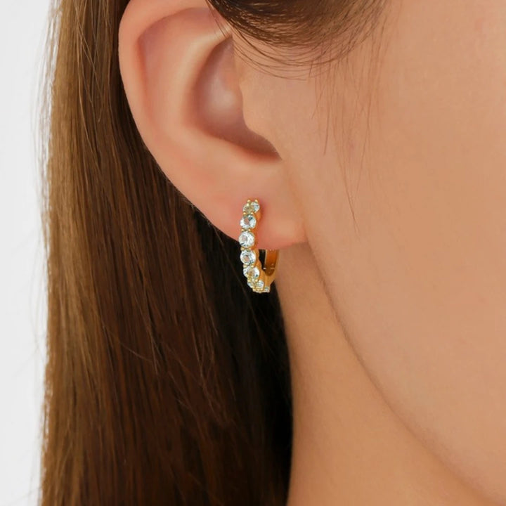Blue Topaz huggie hoop earrings, Gold Plated, worn on ear