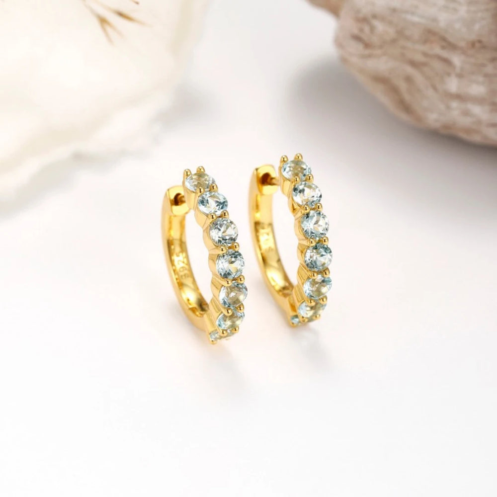 Blue Topaz huggie hoop earrings, Gold Plated, styled photo