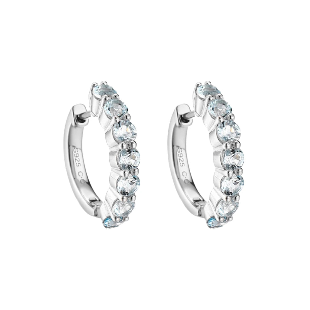 Blue Topaz huggie hoop earrings, Sterling Silver, on white background