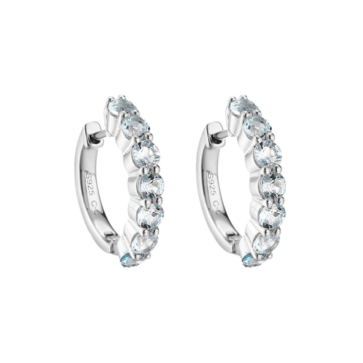 Blue Topaz huggie hoop earrings, Sterling Silver, on white background