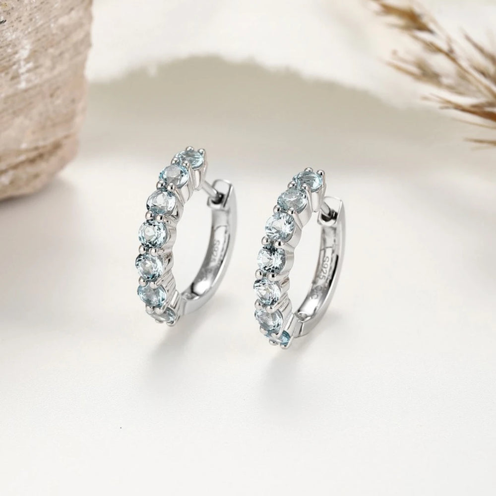 Blue Topaz huggie hoop earrings, Sterling Silver, styled photo