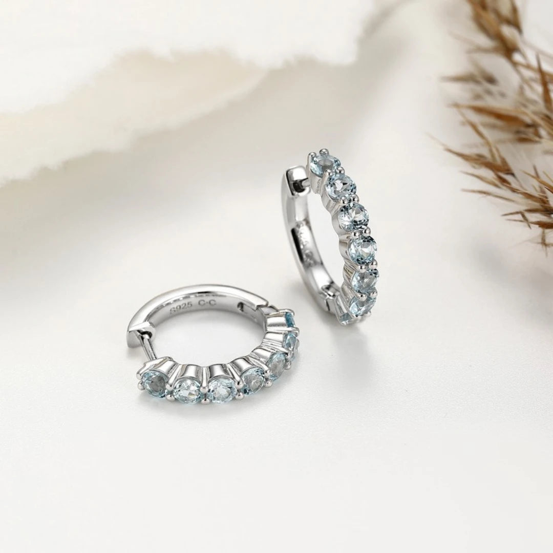Blue Topaz huggie hoop earrings, Sterling Silver, styled photo