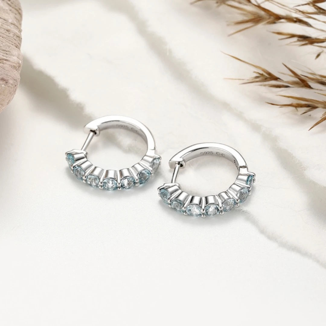 Blue Topaz huggie hoop earrings, Sterling Silver, styled photo